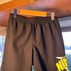 Nike Black Athletic Shorts with Vibrant Yellow Logo